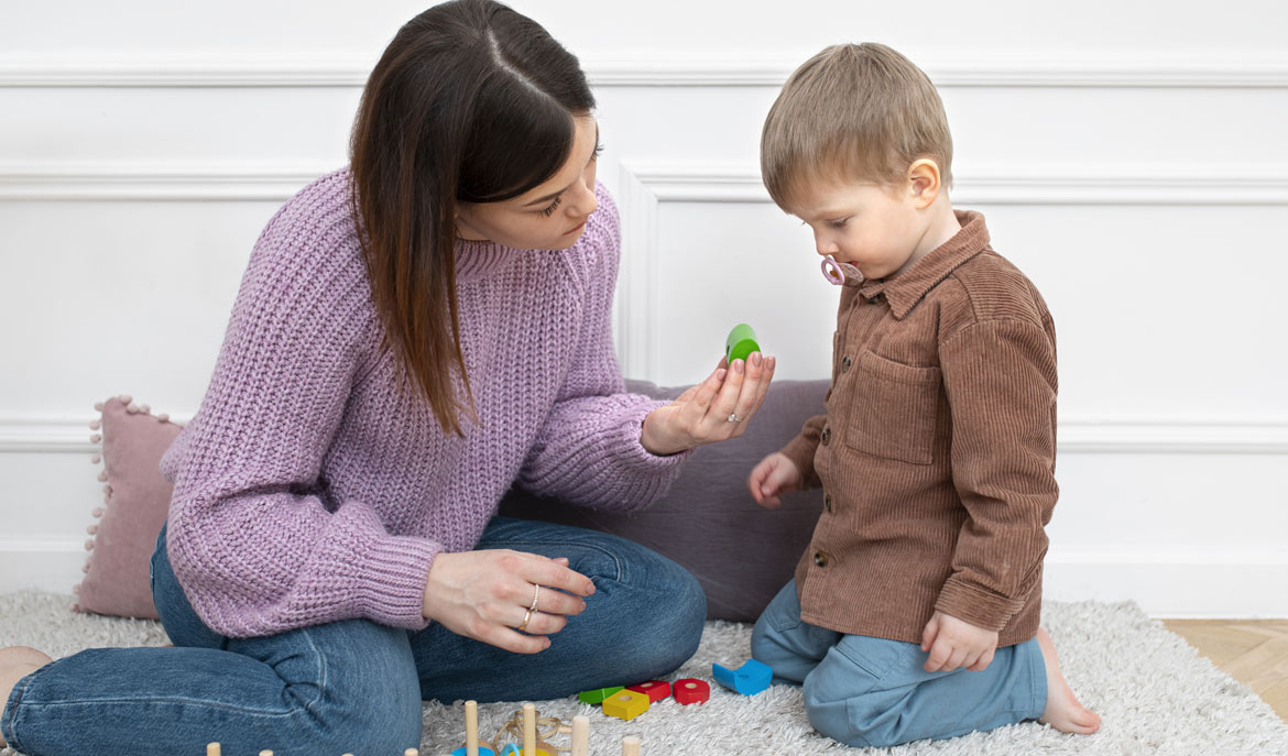 Child and ABA Therapist interacting with wooden blocks | ABA Therapy – Being Different – Making a Difference, a blog from Positive Behavior Services